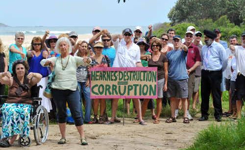 Coffs Harbour City councillor John Arkan (far right), at a Hearnes Lake protest rally, is questioning the need to go down the path of legal action over the controversial development. Coffs Harbour City councillor John Arkan (far right), at a Hearnes Lake protest rally, is questioning the need to go down the path of legal action over the controversial development.